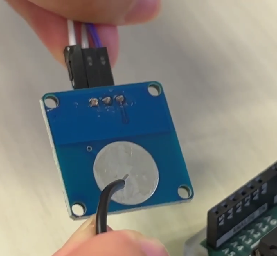 Testing which materials trigger the touch sensor successfully. (The answer was metal and skin, but not plastic!)